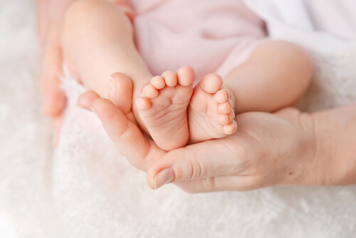 Baby's Feet Held in Mother's Hands - Birth Injury Cases