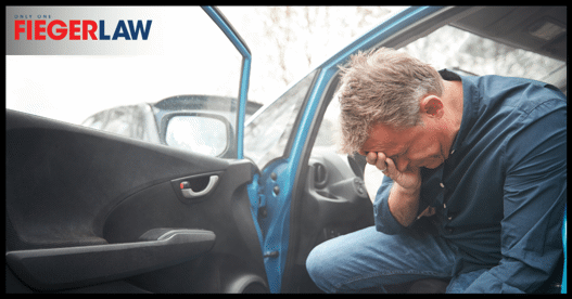 man holding head after a car accident