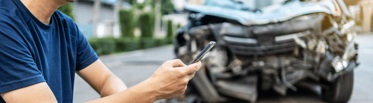 a person using a cell phone after car accident