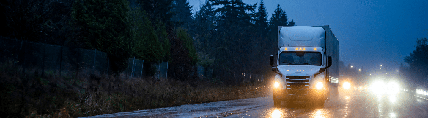 a truck driving down a dirt road