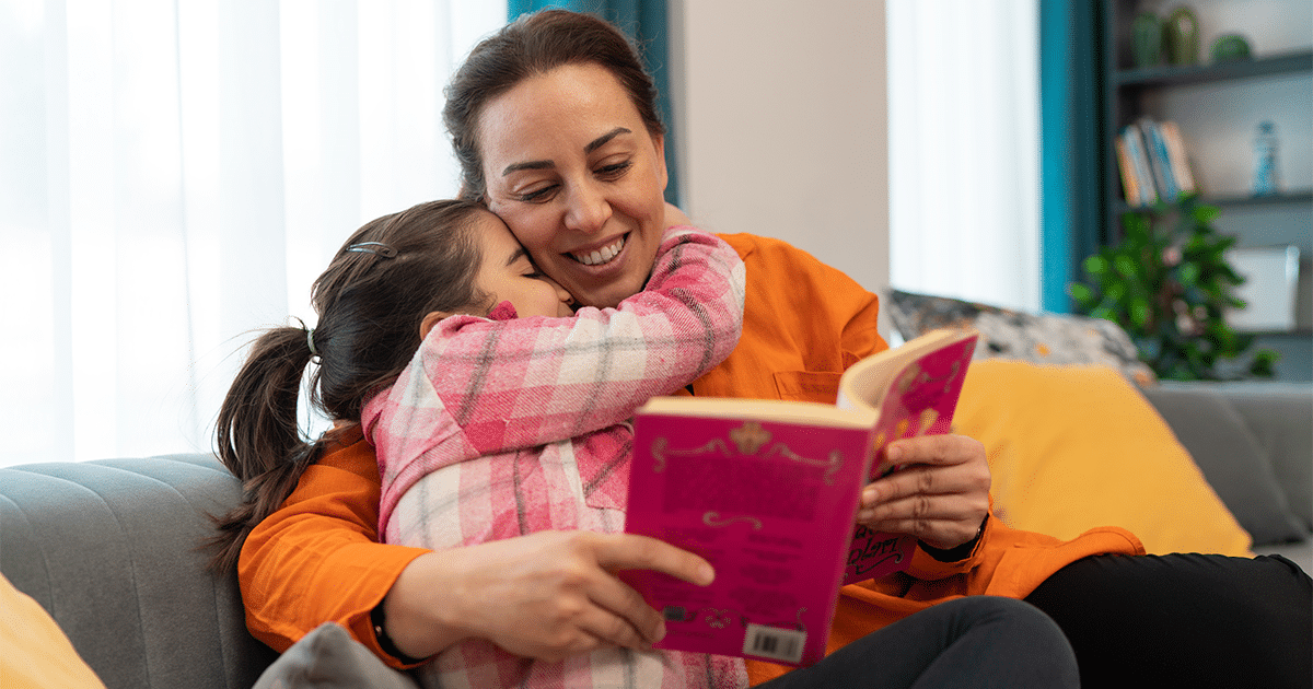 a woman reading a book to child