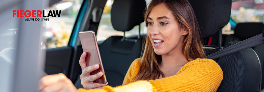 a woman in a car looking at a phone