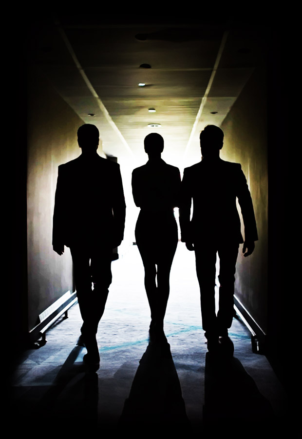 Fieger Lawyer Silhoettes a group of people walking in a dark hallway
