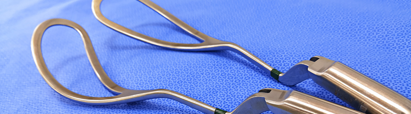 a pair of metal tongs on a blue surface