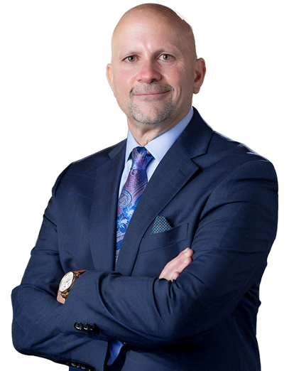 Professional man in a suit with arms crossed, exuding confidence and authority in a corporate setting.