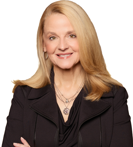 Professional woman in black blazer smiling confidently with arms crossed, standing against a warm gradient background.